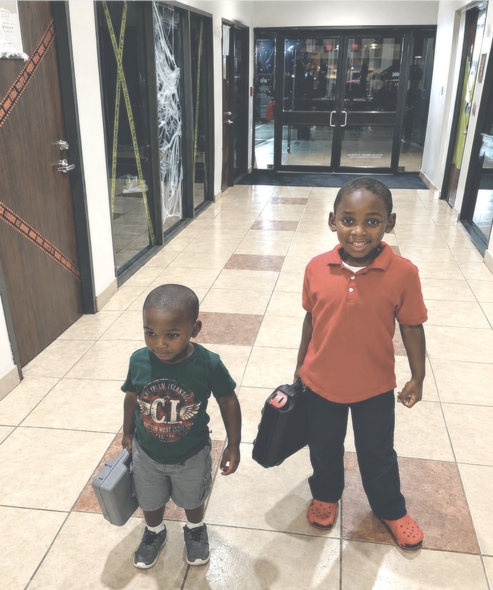 Jouvonna's two sons carrying toolboxes the night the clinic was built, October 20, 2015